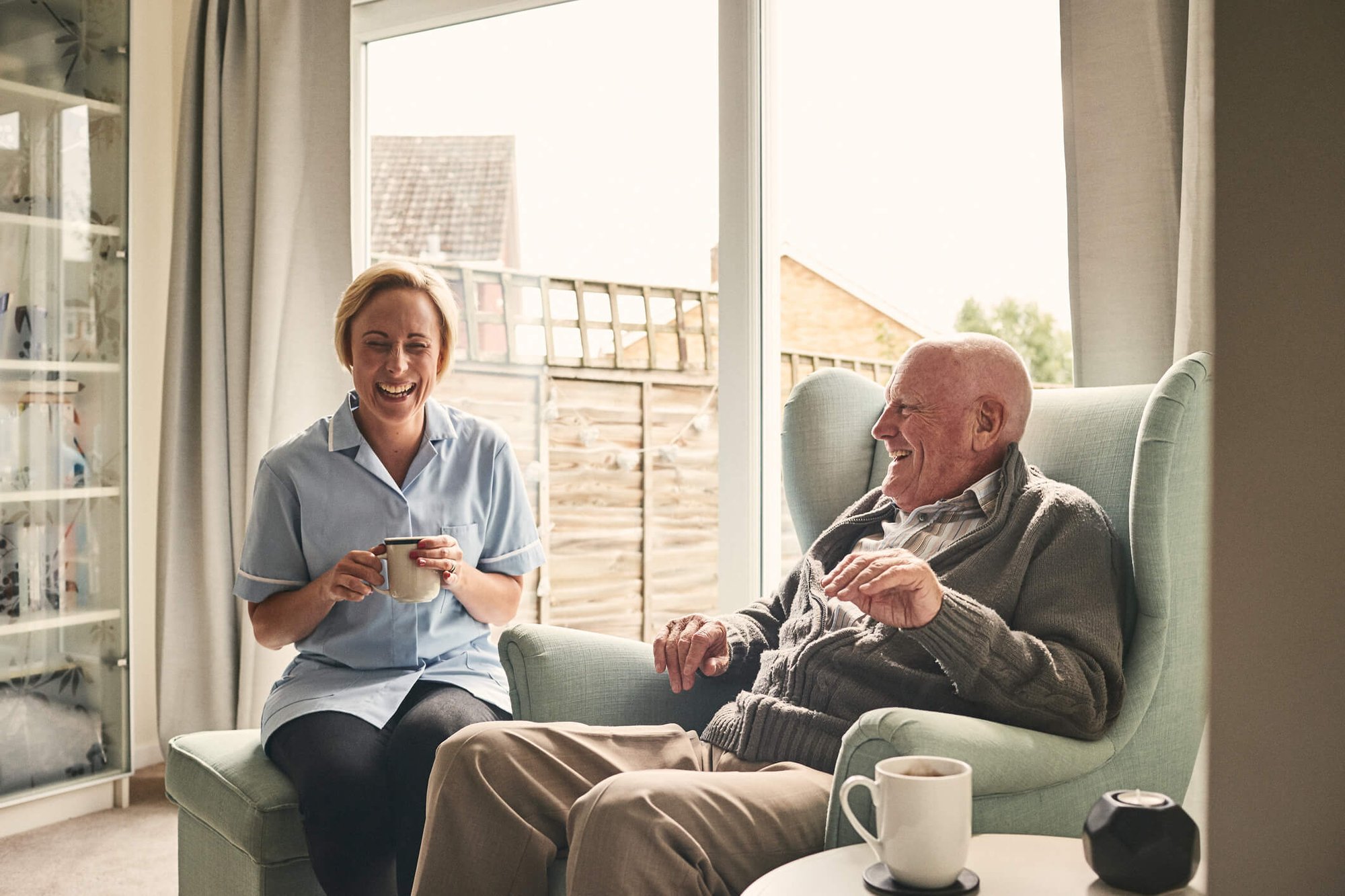 Aged carer with coffee at home