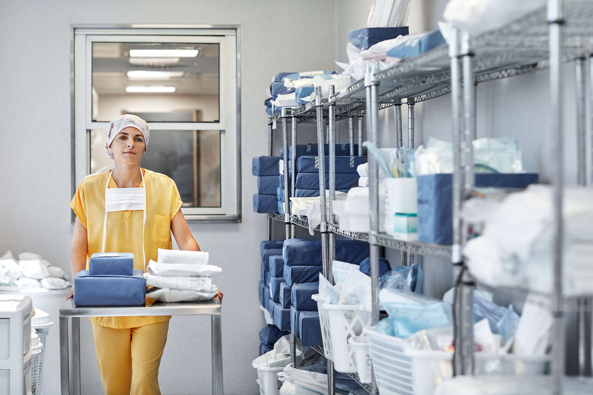 Woman with medical supply shelves